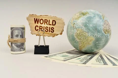 On the table are dollars, a globe and there is a sign with the inscription .. Stock Photos