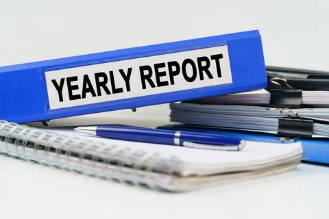 On the table are a notebook, a pen, documents and a folder with the inscripti Stock Photos