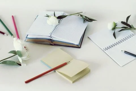 On the table are paper, books, empty notebooks, pencils Stock Photos