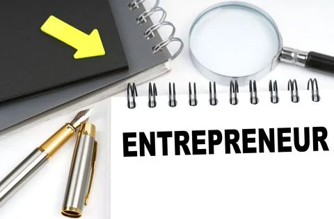 On the table are a pen and a notebook with the inscriptions - entrepreneur Stock Photos