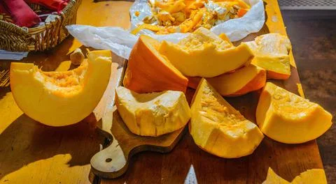 On the table are pieces of pumpkin cleared from the pulp that went to waste. Stock Photos