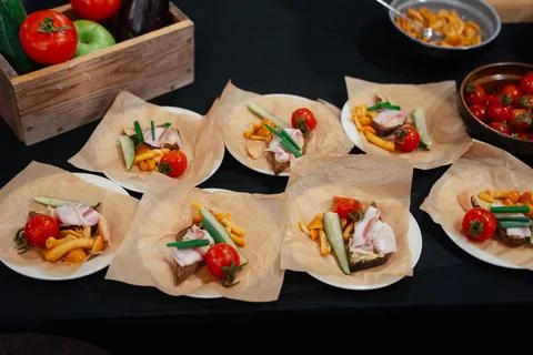 On the table are ready-made individual cold appetizers with bacon, mushrooms, Stock Photos