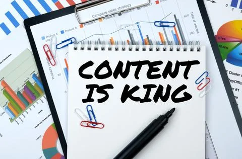 On the table are reports, charts, a notebook with the inscription - CONTENT I Stock Photos