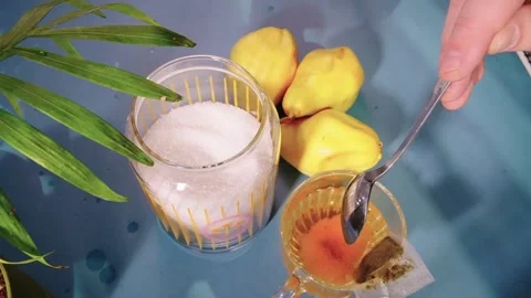 On the table are sugarv and an empty tea cup with a spoon. It is filled with tea Stock-Footage 303639277
