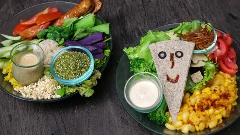 On the table are two plates with delicious and healthy vegan food for health and Stock Footage 220504205