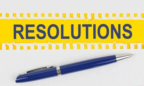 On the table are two sheets from a notebook and a pen on a yellow background  Stock Photos