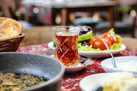Table With an Array of Food Plates and a Salad Bowl Fotos de archivo