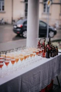Table with an array of refreshments and bottles of alcohol outdoors Stock Photos