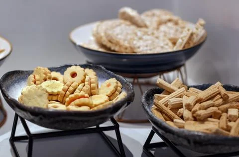 The table with an array of snacks, including bowls of colorful cookies and li Fotos de archivo