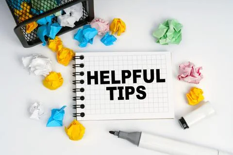 On the table is a basket, multi-colored paper and a notebook with the inscrip Stock Photos