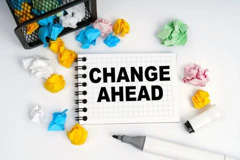 On the table is a basket, multi-colored paper and a notebook with the inscrip Stock Photos