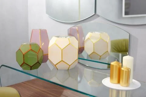 On the table in the bedroom are three multi-colored vases, they are reflected Stock Photos