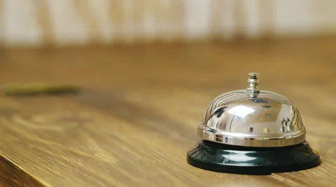 Table bell at the reception, hand rings the bell Stock Footage 66372071