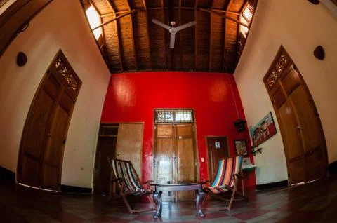 Table between two deck chair  inside old colonial house with wood ceiling and Stock Photos