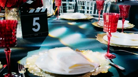 Table with blue-red serving. Glasses, plates and cutlery Stock Footage 196805494
