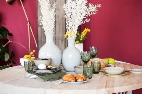 Table in the boho style with pineapple candles plant decoration with a set of Stock Photos