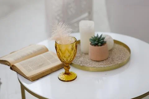A table with a book and a vase Stock Photos