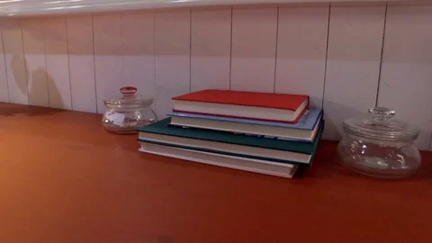 A table with books and a vase. Stock Footage 79165236