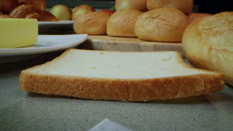 On the table breakfast items, buns, apples, butter, garlic kurosan, egg cake Stock Footage 201272399