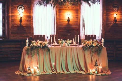 Table for bride and groom with decor, flowers, candles and dishes 写真素材