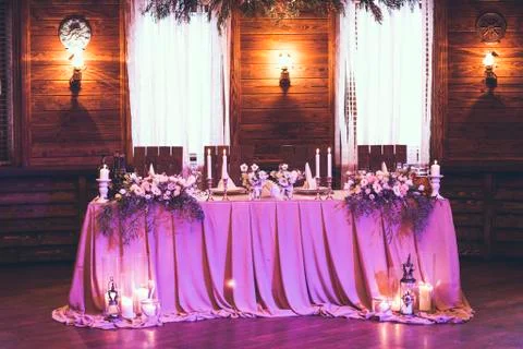 Table for bride and groom with decor, flowers, candles and dishes 写真素材