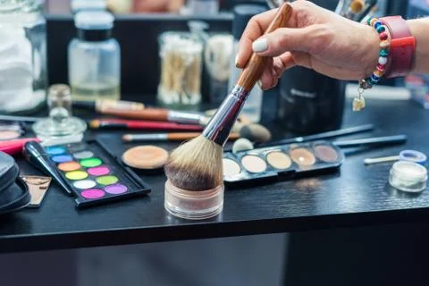 Table with brushes for make up and instruments for visage Stock Photos