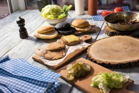 Table with burger ingredients. Stock Photos