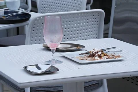 A table in a cafe after the visitors have finished their meal Stock Photos