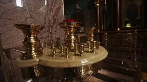 Table for candles against the background of a marble column in an orthodox Stock Footage 233904265