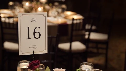 Table card label for formal luxury wedding with chairs setting in background 库存影片 104820396