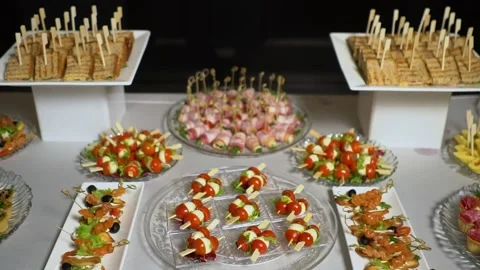 A table with catering is covered with a black cloth. Stock Footage 159366842