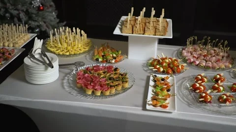 A table with catering is covered with a black cloth. Stock Footage 159366891
