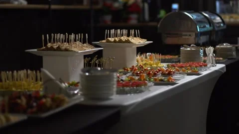 A table with catering is covered with a black cloth. Stock Footage 159366911