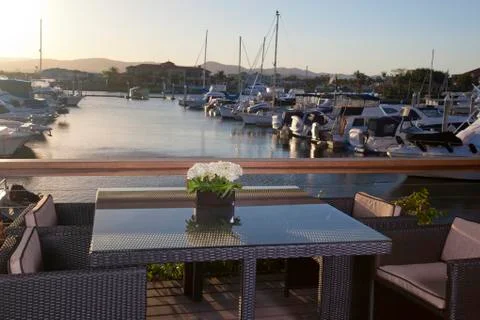 Table with chairs in front of a marina Stock Photos