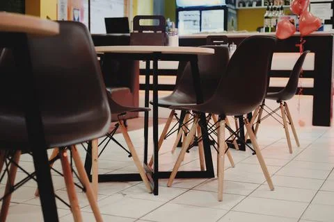 Table with chairs in the interior of a modern cafe Stock Photos