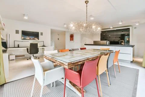 Table with chairs in modern dining room Stock Photos