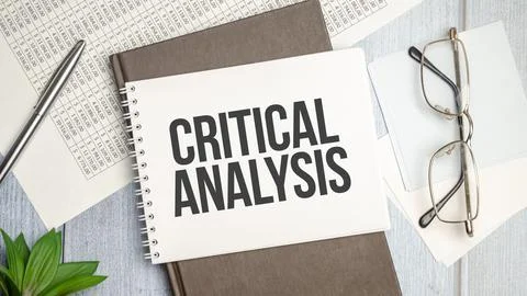 On the table charts, calculator and notebook with the inscription CRITICAL AN Stock Photos