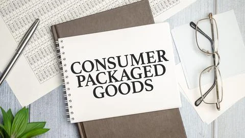 On the table charts, calculator and notebook with the CPG - Consumer Packaged Stock Photos