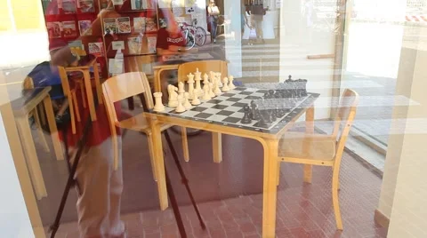 Table with chess game and reflexes of tourists and traffic Stock Footage 66965867