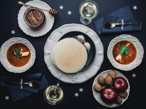 Table with Christmas dinner for two. Fish soup and white wine. Stock Photos