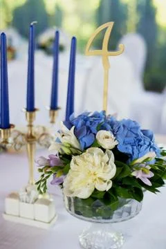 Table with a classic design. With a composition in a high vase with hydrangeas Stock Photos