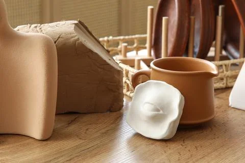 Table with clay and plaster figures in sculptor's workshop, closeup Stock Photos