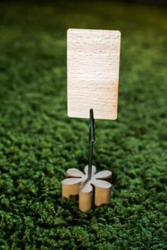 Table clip card note holder with wooden flower and a blank card for copywriting Stock Photos