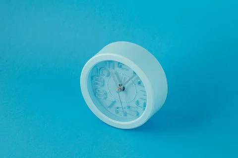 Table clock isolated on blue background, horizontal image, top view Illustration