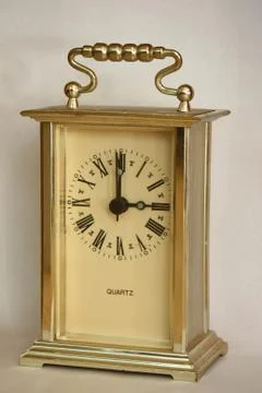 Table clock, showing three o'clock. Photos