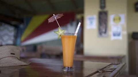 On the table is a cocktail with mango Stock Footage 154807137