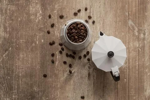 Table with coffee maker on it full of coffee beans Stock Photos