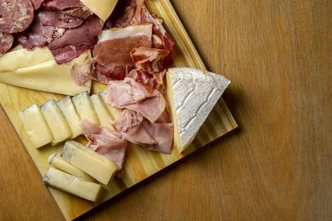 Table with cold cuts and cheeses Stock Photos