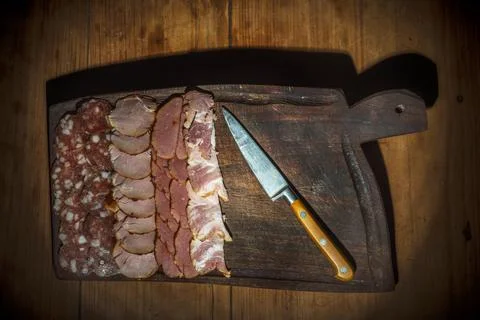 Table with cold cuts and knife Stock Photos