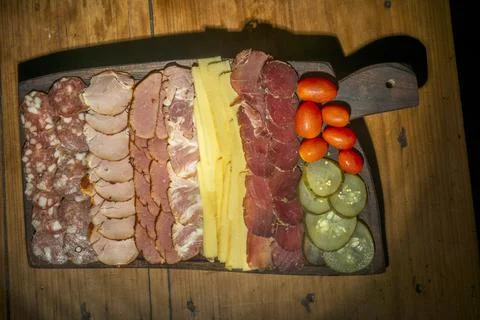 Table of cold cuts, cherry tomatoes and cucumbers Stock Photos